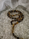 Close-up of natural amber beads with unique texture and polished surface – premium handmade prayer rosary
