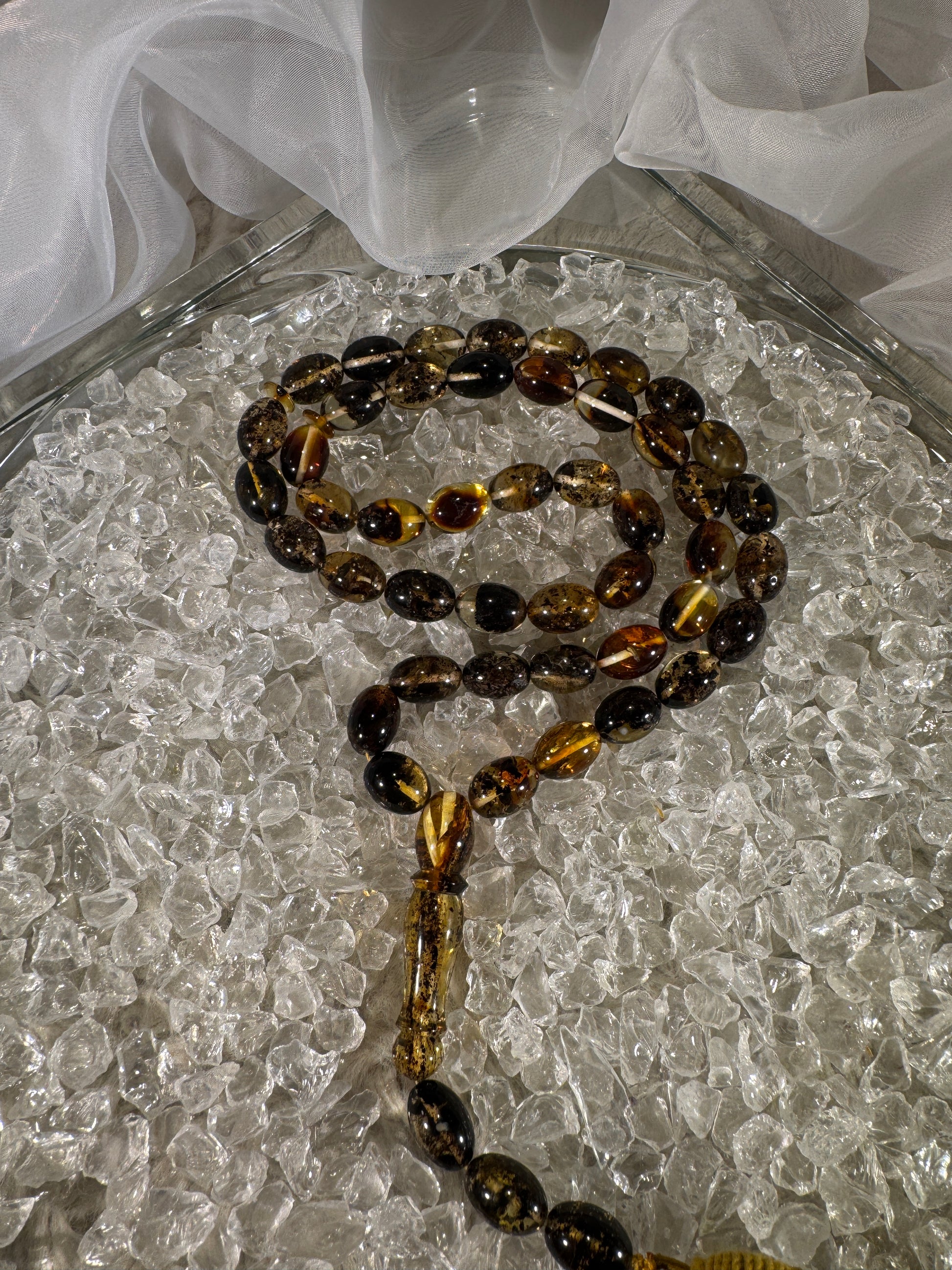 Close-up of natural amber beads with unique texture and polished surface – premium handmade prayer rosary