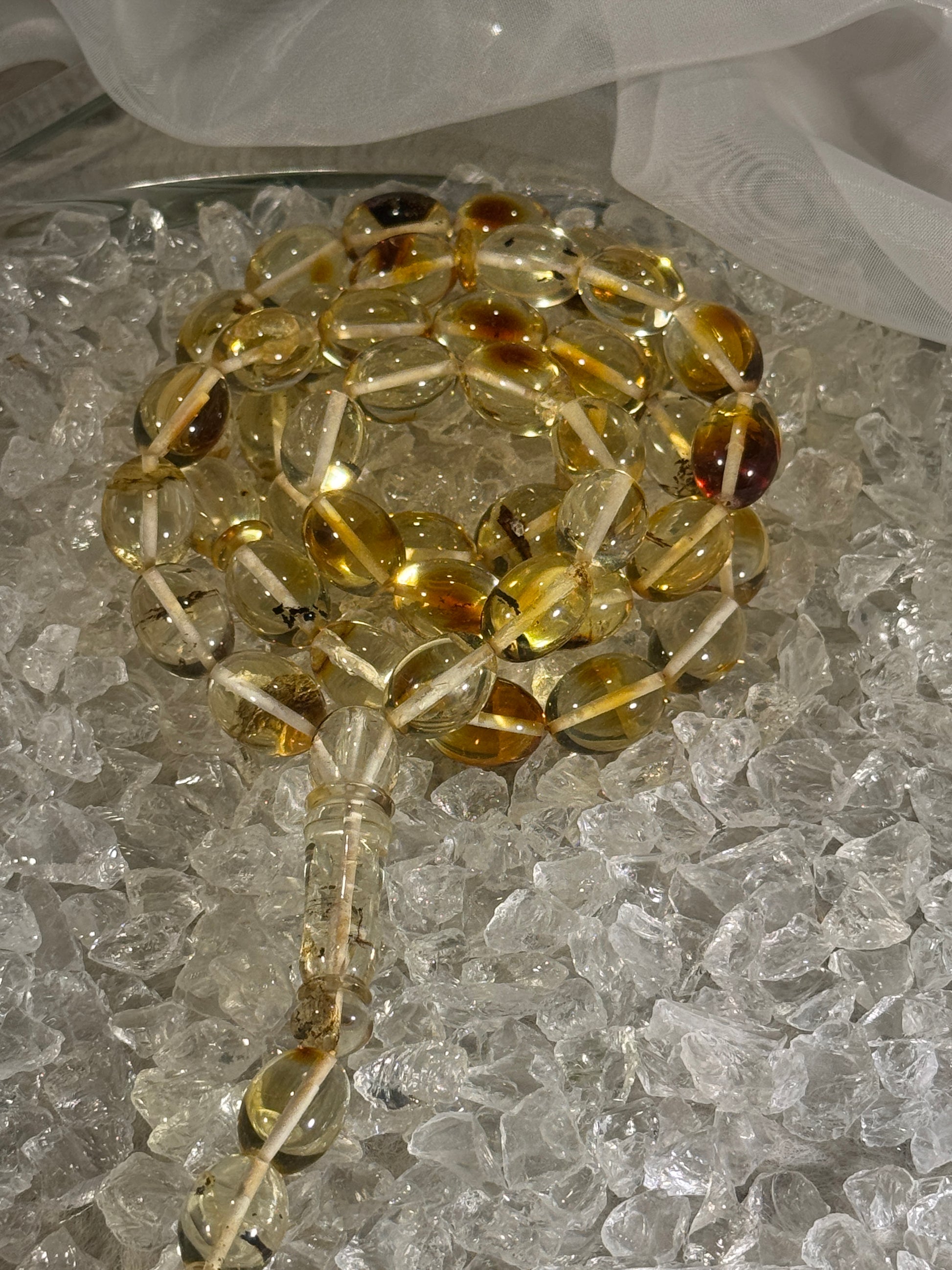 Close-up of natural amber beads with unique texture and polished surface – premium handmade prayer rosary.