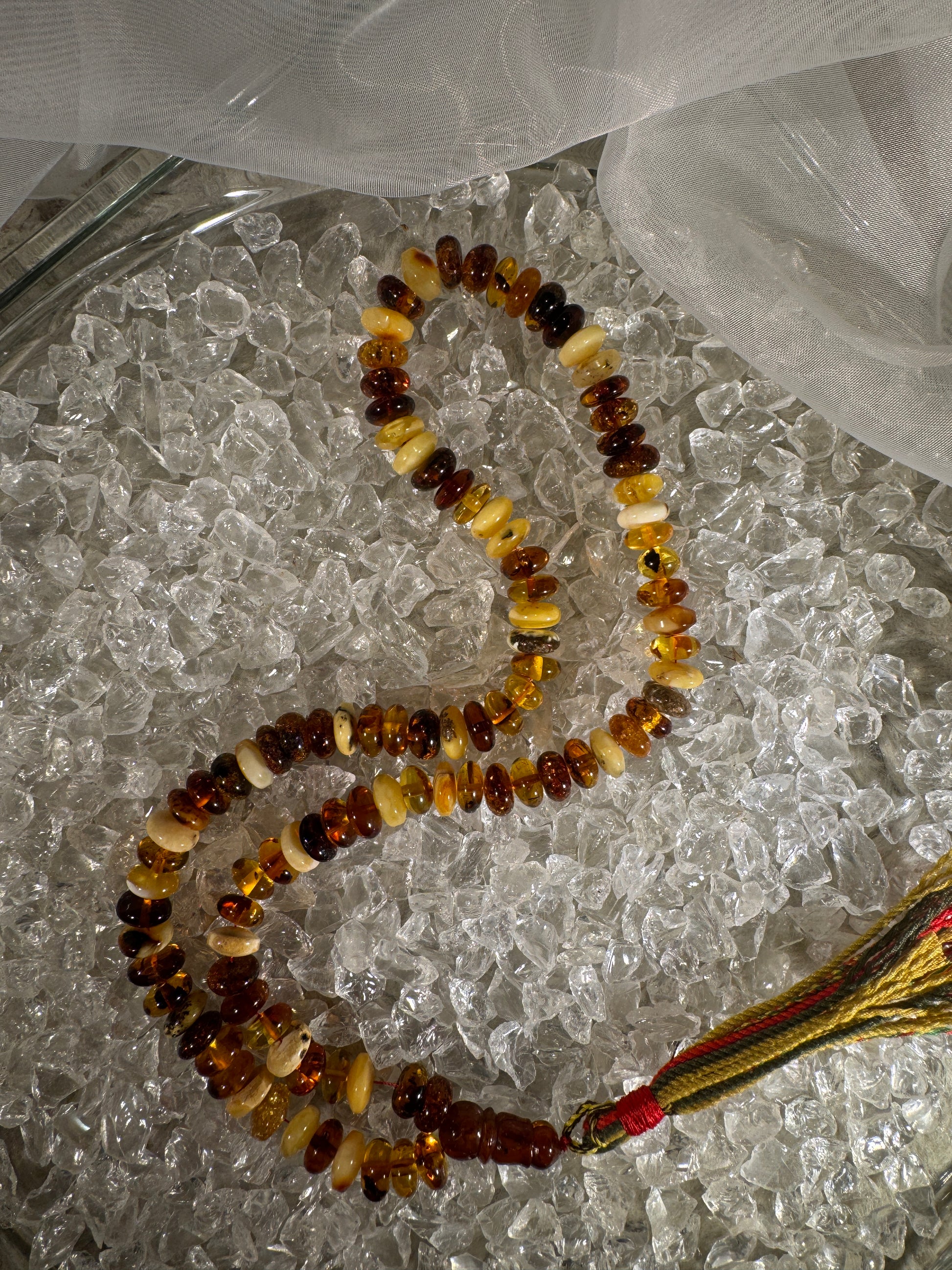 Close-up of natural amber beads with unique texture and polished surface – premium handmade prayer rosary.