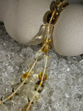 Close-up of natural amber beads with unique texture and polished surface – premium handmade prayer rosary