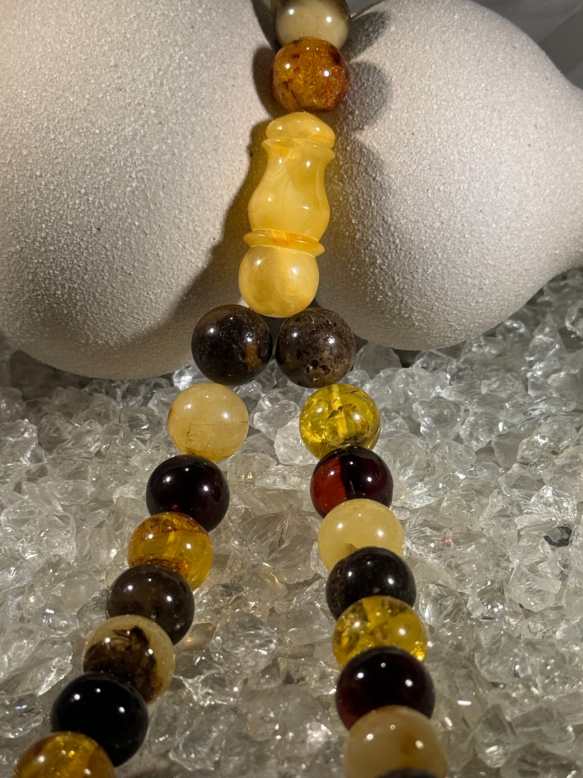 Close-up of natural amber beads with unique texture and polished surface – premium handmade prayer rosary."