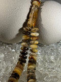 Close-up of natural amber beads with unique texture and polished surface – premium handmade prayer rosary