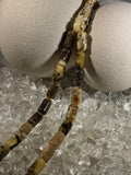 Close-up of natural amber beads with unique texture and polished surface – premium handmade prayer rosary.