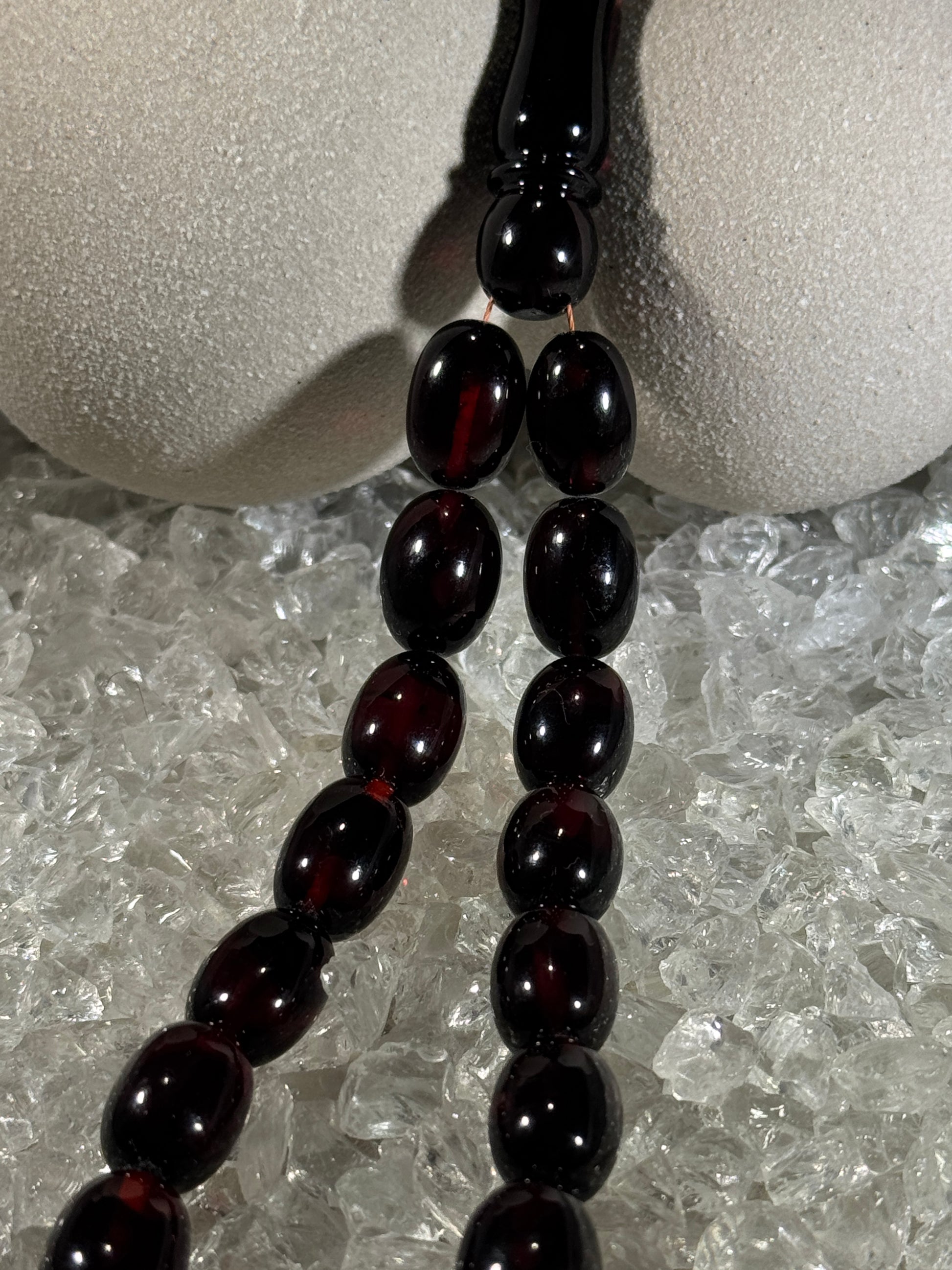 Close-up of natural amber beads with unique texture and polished surface – premium handmade prayer rosary