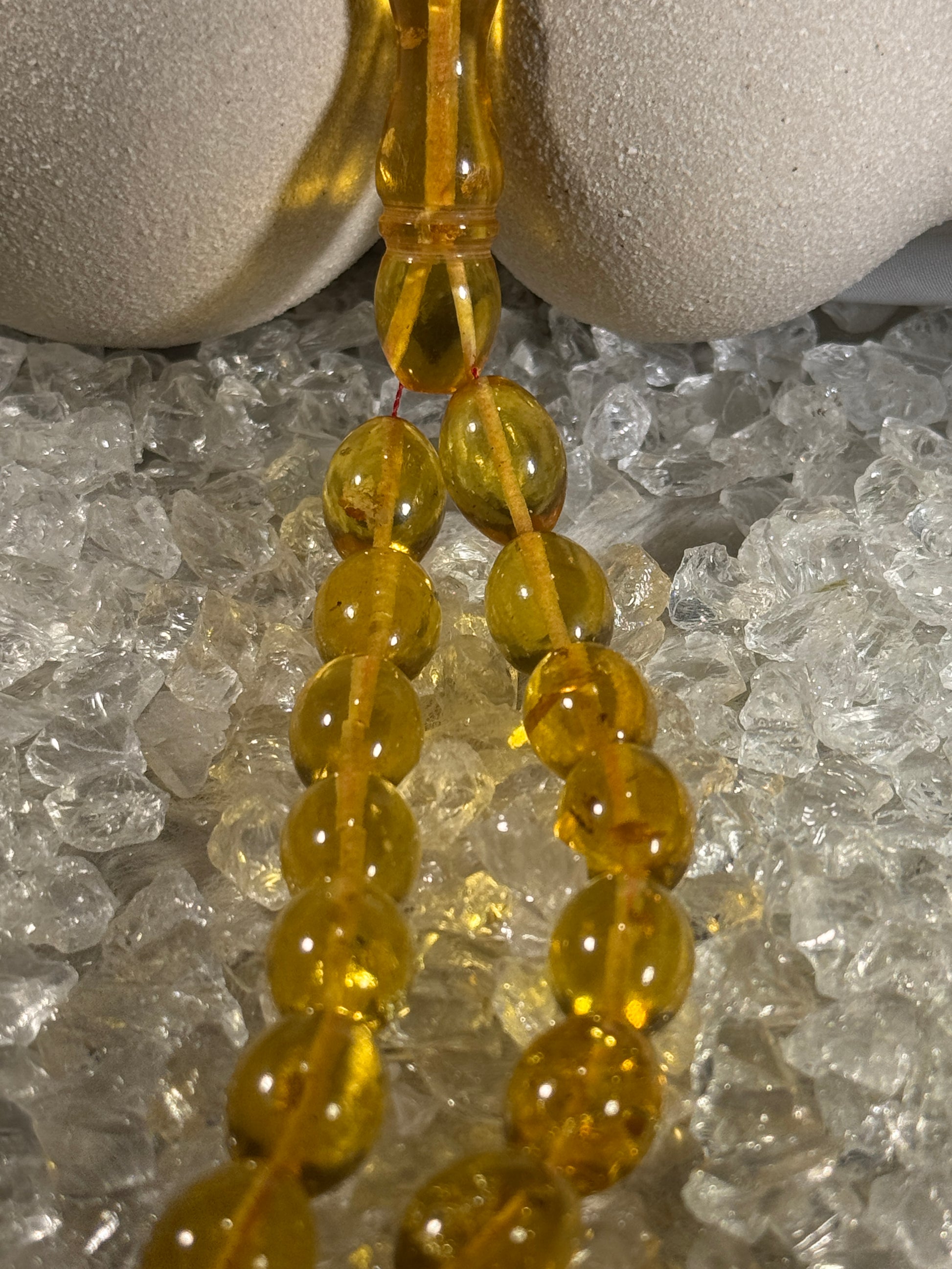 Close-up of natural amber beads with unique texture and polished surface – premium handmade prayer rosary