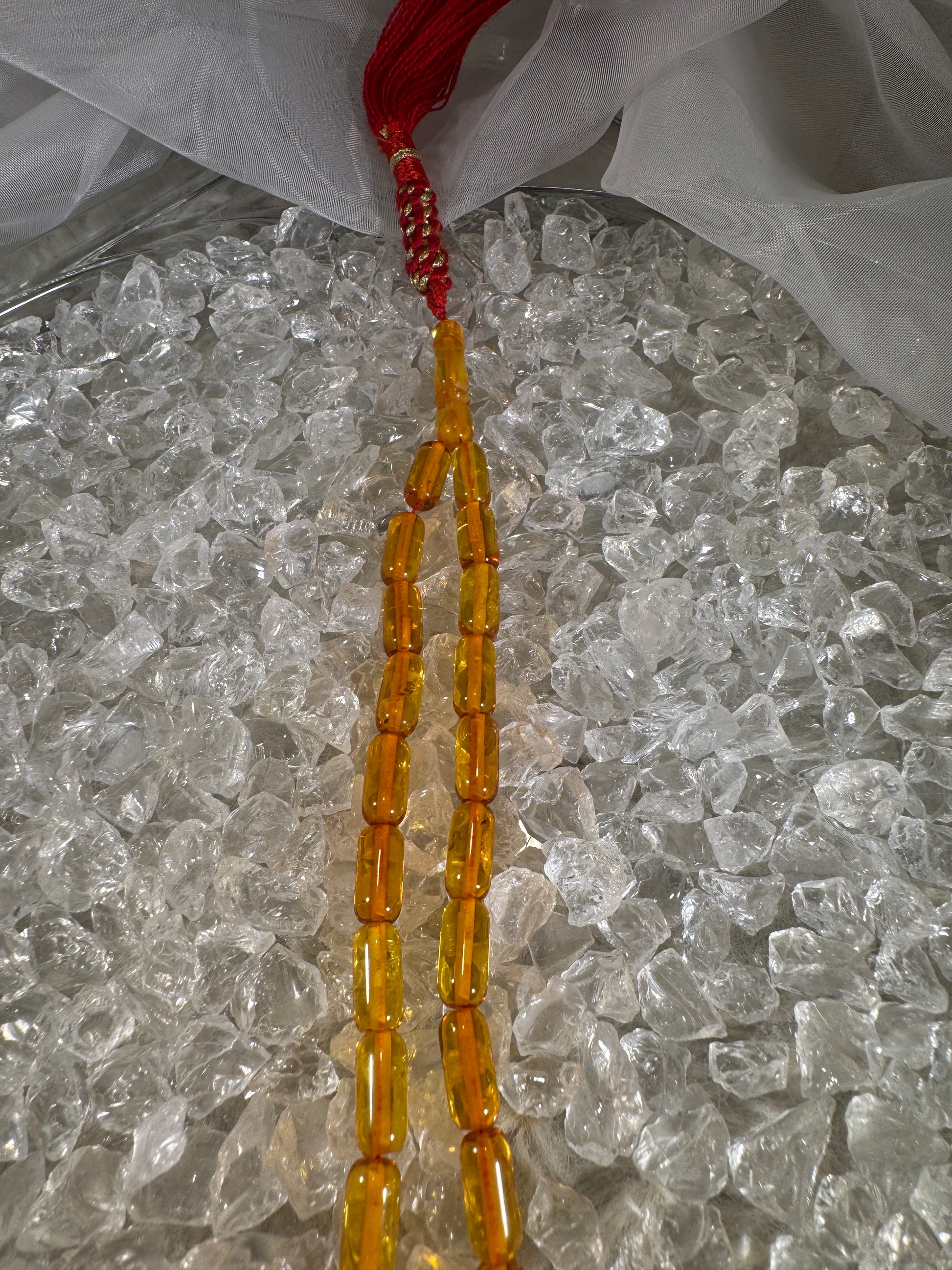 Close-up of natural amber beads with unique texture and polished surface – premium handmade prayer rosary.