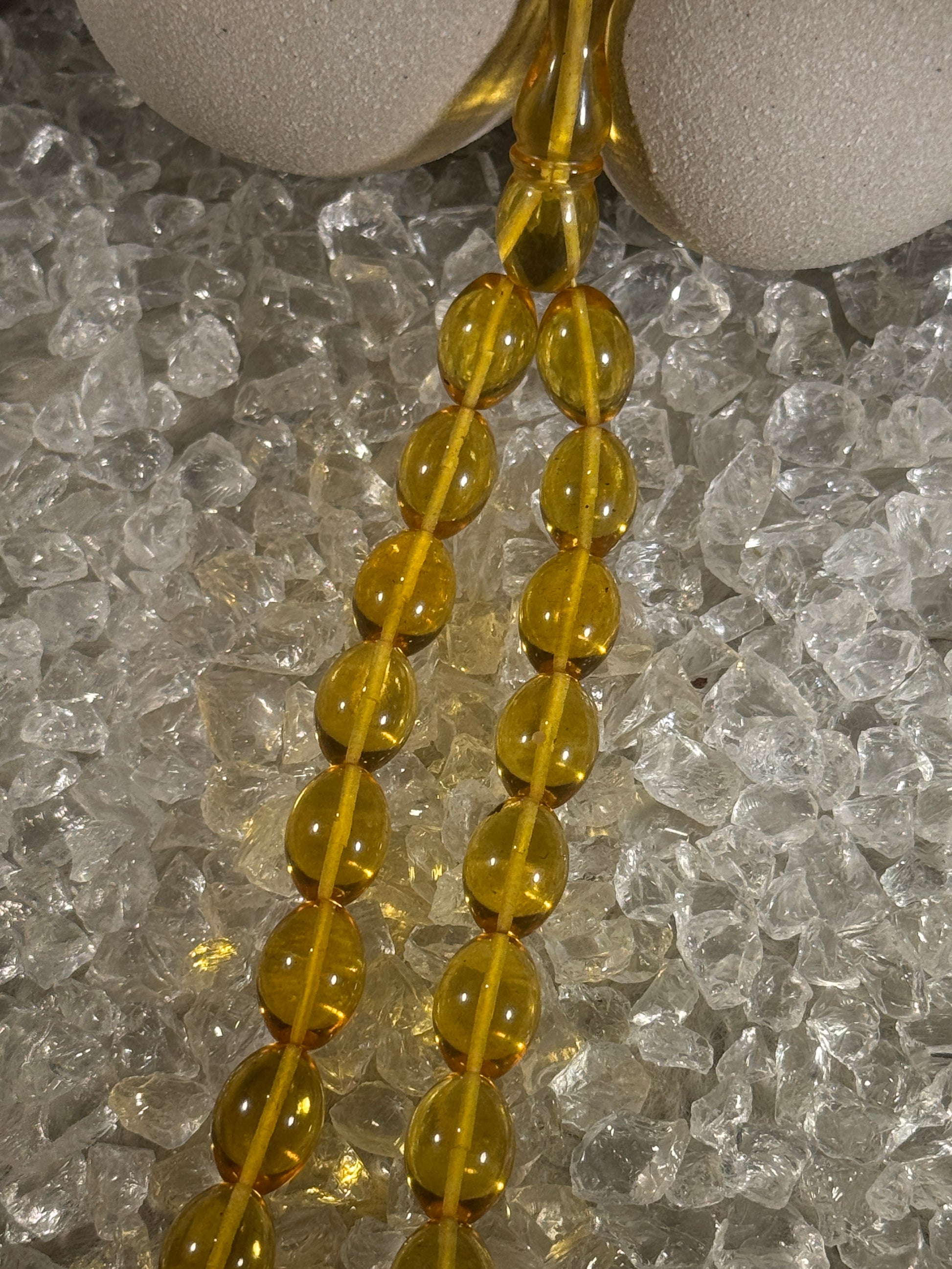 Close-up of natural amber beads with unique texture and polished surface – premium handmade prayer rosary